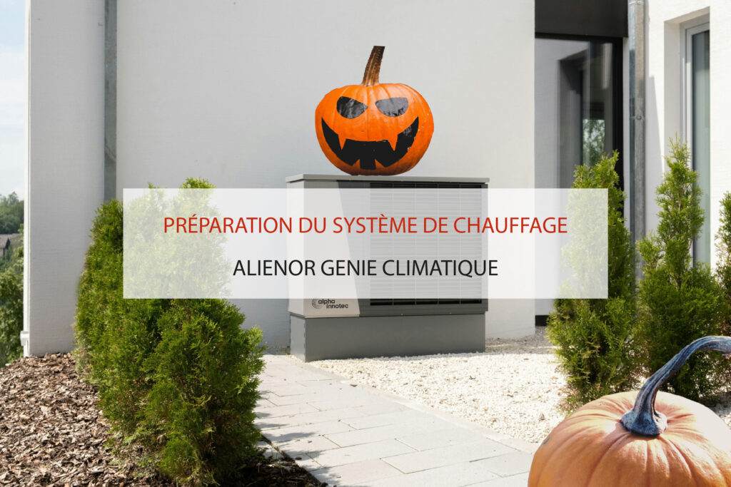 Citrouille déguisée pour Halloween posée sur une pompe à chaleur, regardant une autre citrouille en avant-plan devant une maison.